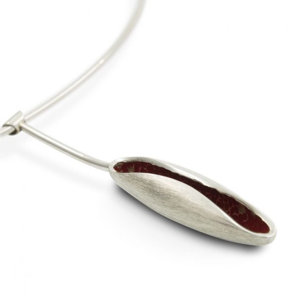 Collar de plata 925 compueto de gargantilla rígida (longitud opcional 42, 47 o 52cm), y colgante de 7cm con vaina, acabado mate rallado, con interior lacado en rojo. Cierre de presión. Objeto diseñado y fabricado artesanalmente en Madrid, España, por el estudio-taller de malicia. Este collar ha sido fabricado por personas que disfrutan su trabajo. Colección inspirada en el tríptico sobre madera El Jardín de las Delicias (Museo del Prado, Madrid). El diseño de este collar recrea los crecimientos vegetales representados en el cuadro, los volúmentes huecos, la tensión y rigidez de las figuras, para desarrollar una estética contemporánea y propia.